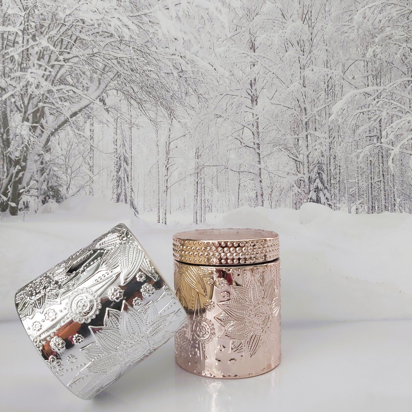 Decorative silver and rose gold jar on a snowy background