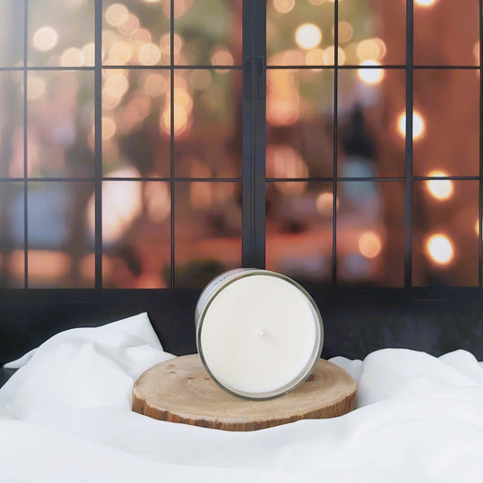 Candle on a wooden coaster with a blurred festive background
