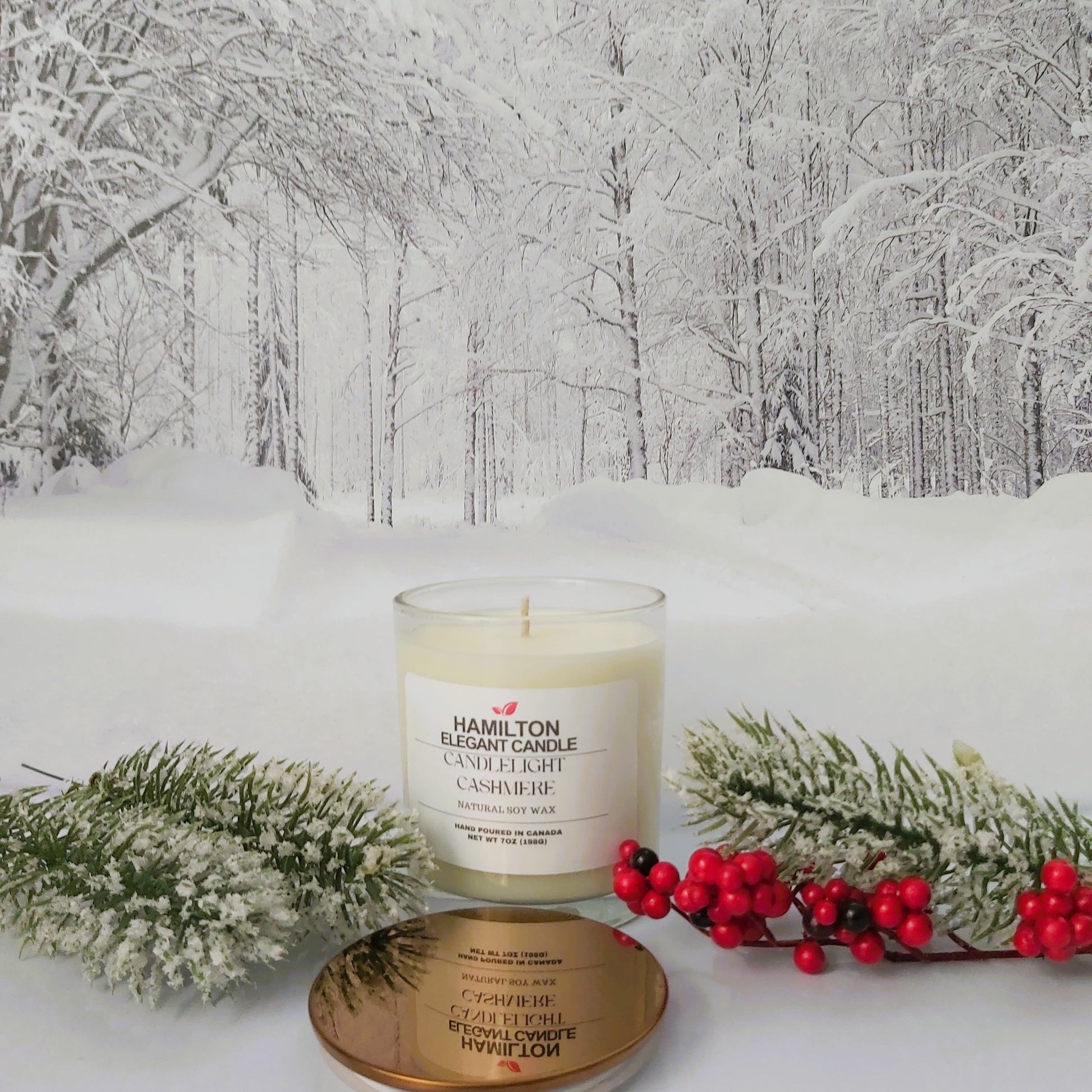 Candle with packaging in a snowy forest setting