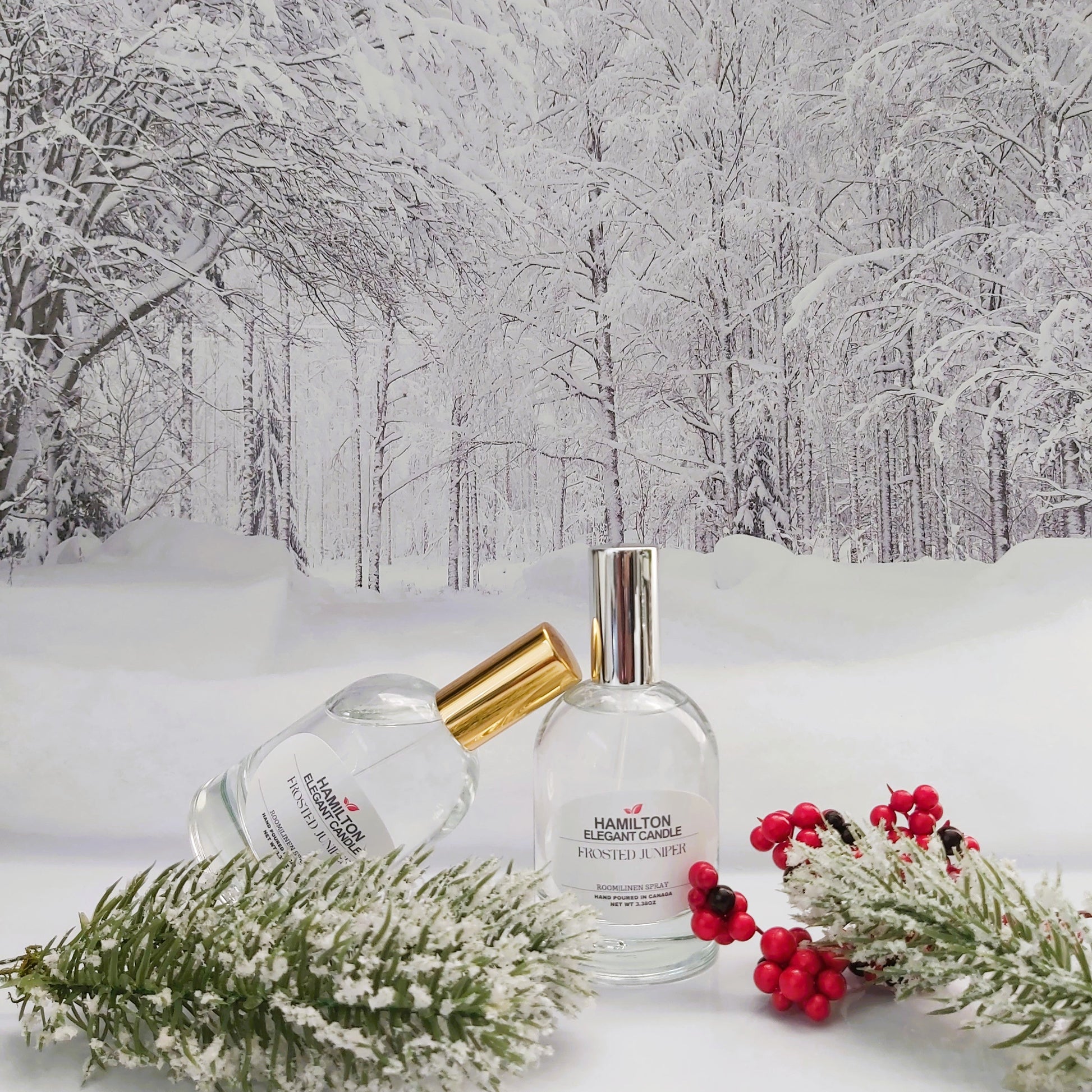 Two perfume bottles on a snowy surface with a winter forest background
