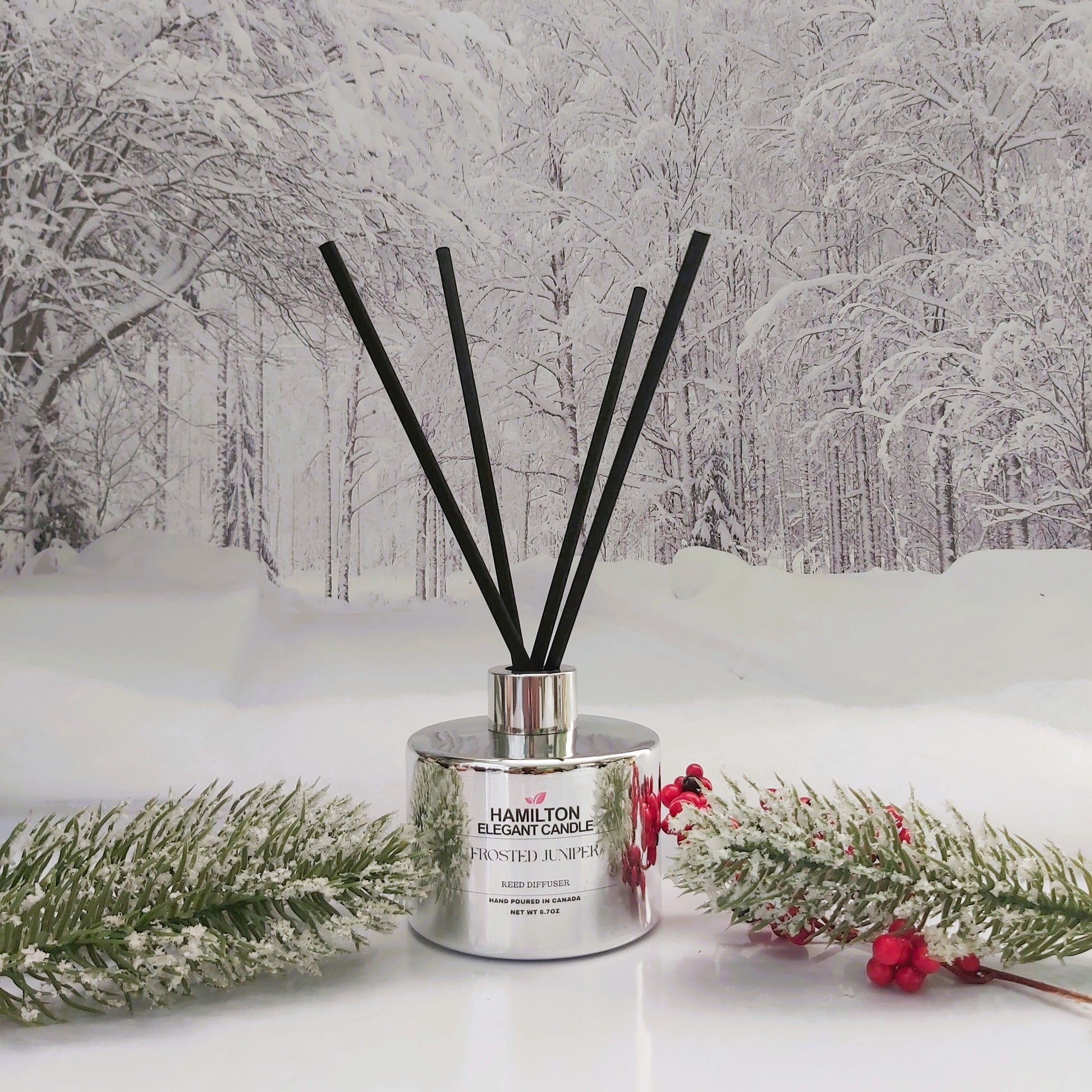 Diffuser with black sticks on a snowy forest background